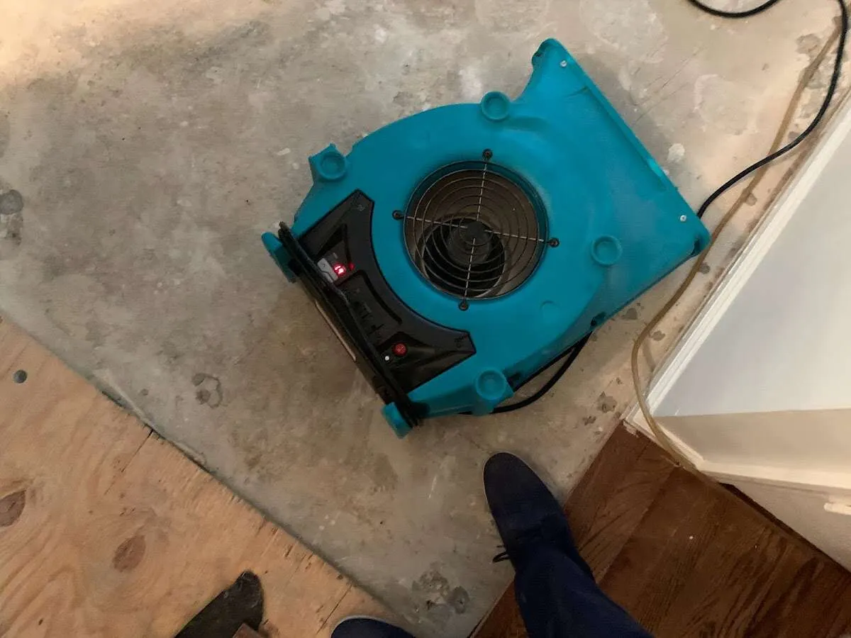 Air mover drying subfloor during Commercial Water Damage Restoration in Indian Hills